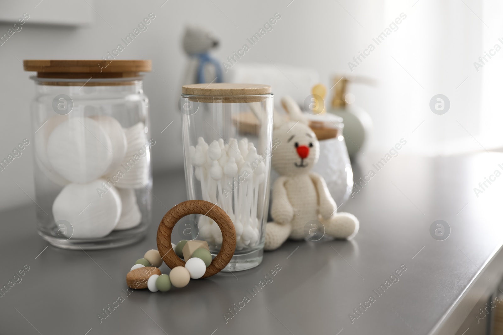 Photo of Baby accessories and toys on table in room