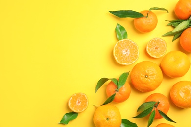 Flat lay composition with ripe tangerines on color background. Space for text