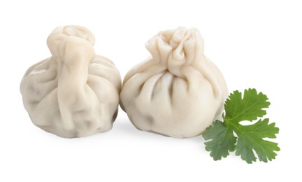 Photo of Two tasty khinkali (dumplings) and parsley isolated on white. Georgian cuisine