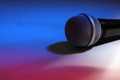 Photo of Modern microphone on color background, closeup. Space for text