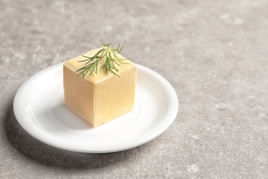 Photo of Plate with fresh butter on table. Space for text