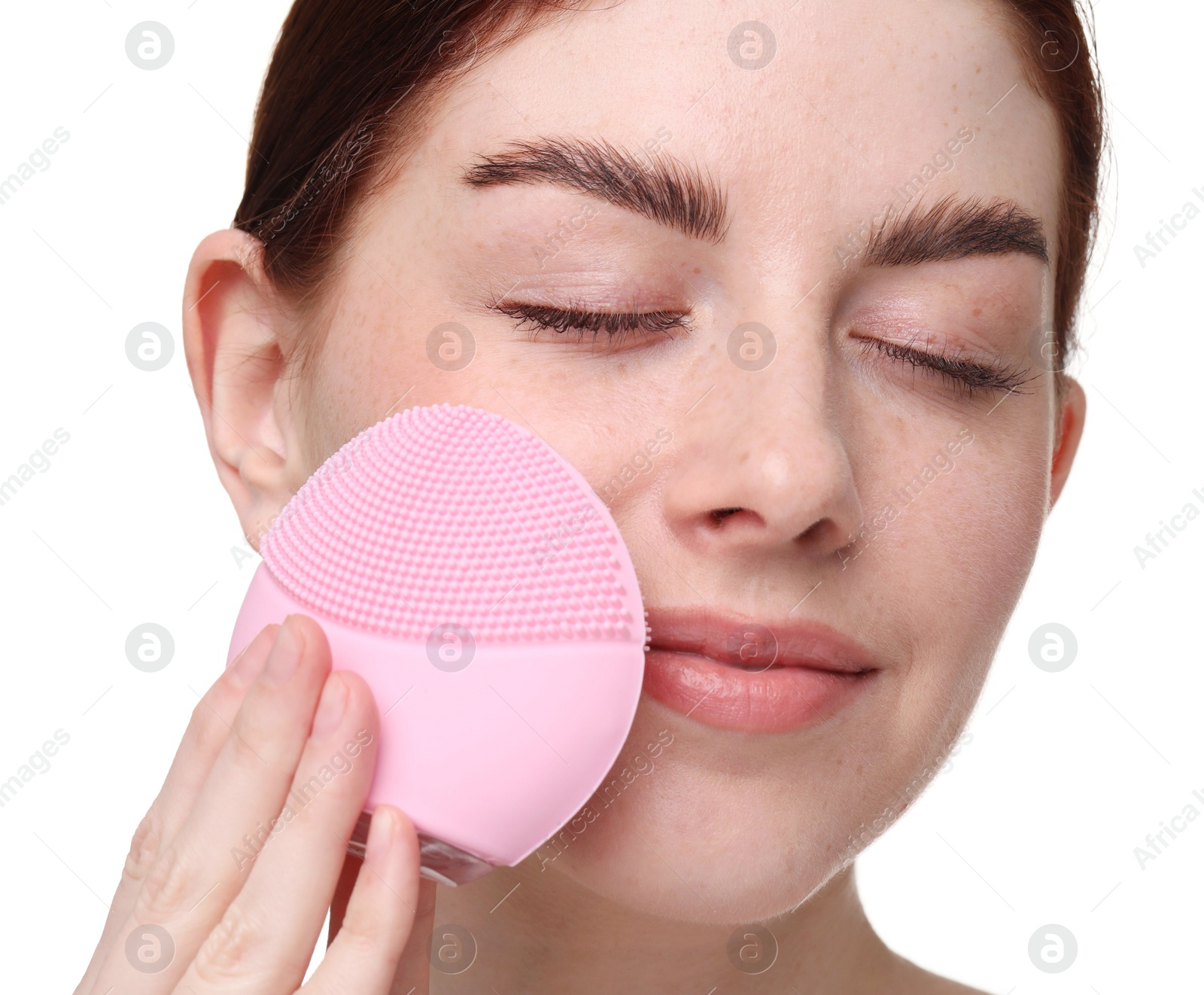 Photo of Washing face. Young woman with cleansing brush on white background, closeup