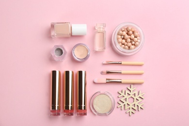 Photo of Flat lay composition with decorative cosmetic products on pink background. Winter care