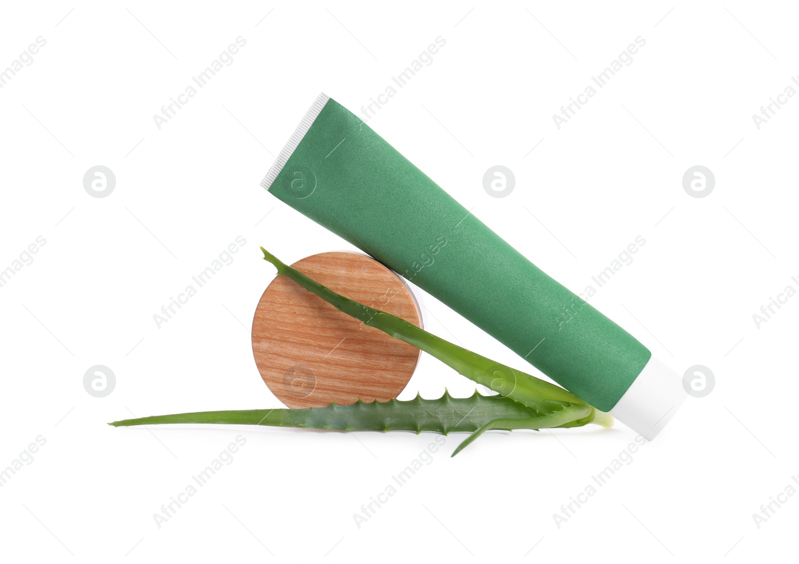 Photo of Tube of toothpaste, aloe vera leaves and wooden decor on white background