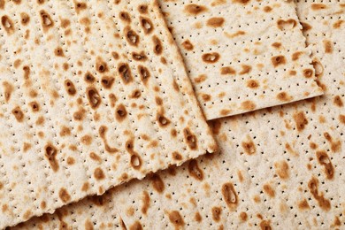 Photo of Traditional matzos as background, top view. Pesach celebration
