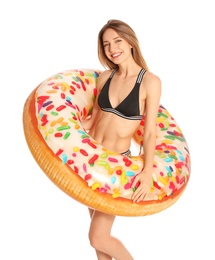 Beautiful young woman in stylish bikini with doughnut inflatable ring on white background