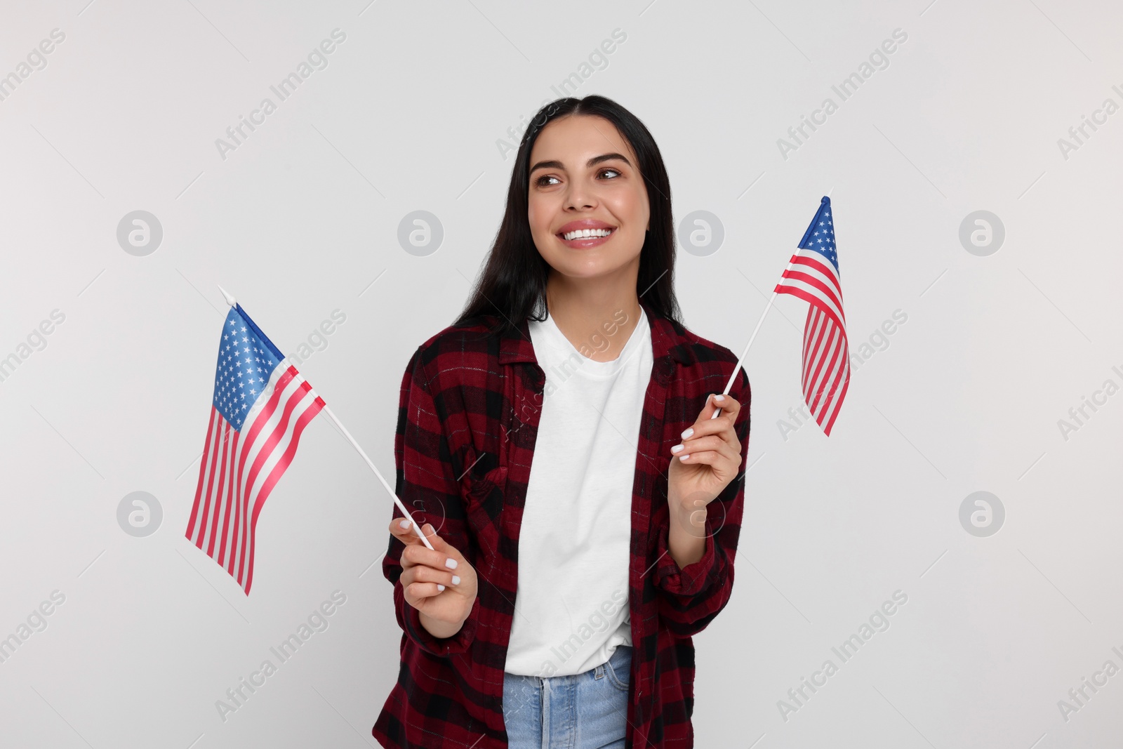 Photo of 4th of July - Independence Day of USA. Happy woman with American flags on white background