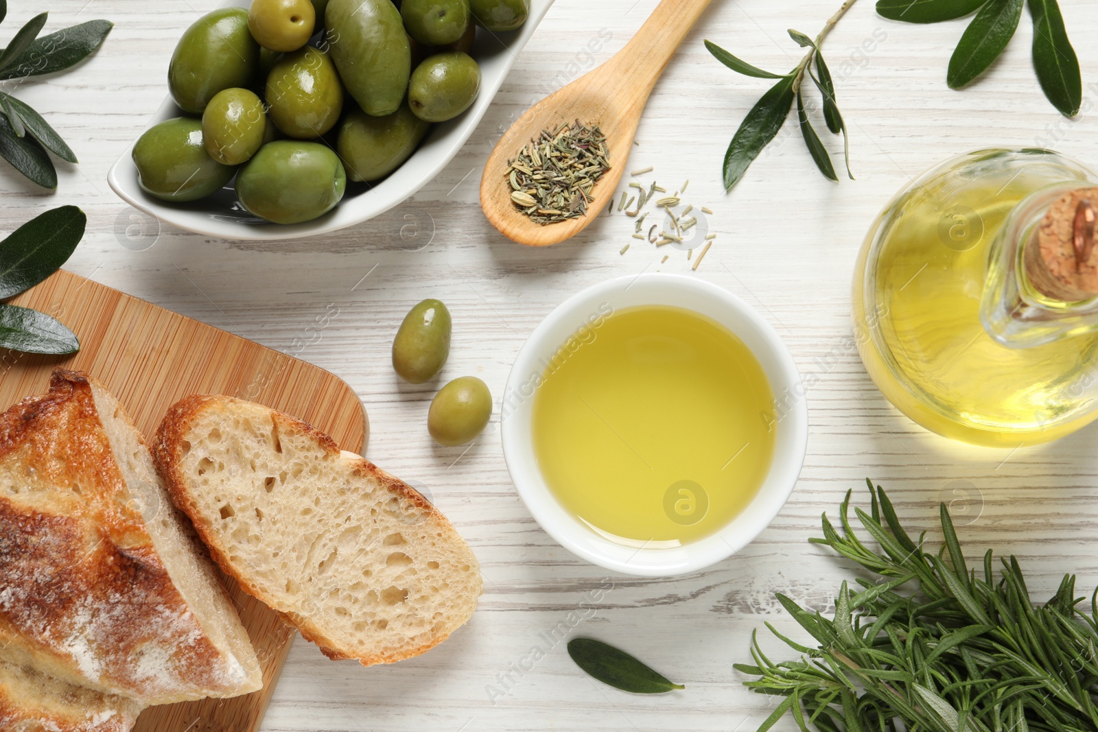 Photo of Flat lay composition with olive oil on white wooden table, flat lay