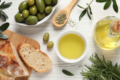 Photo of Flat lay composition with olive oil on white wooden table, flat lay