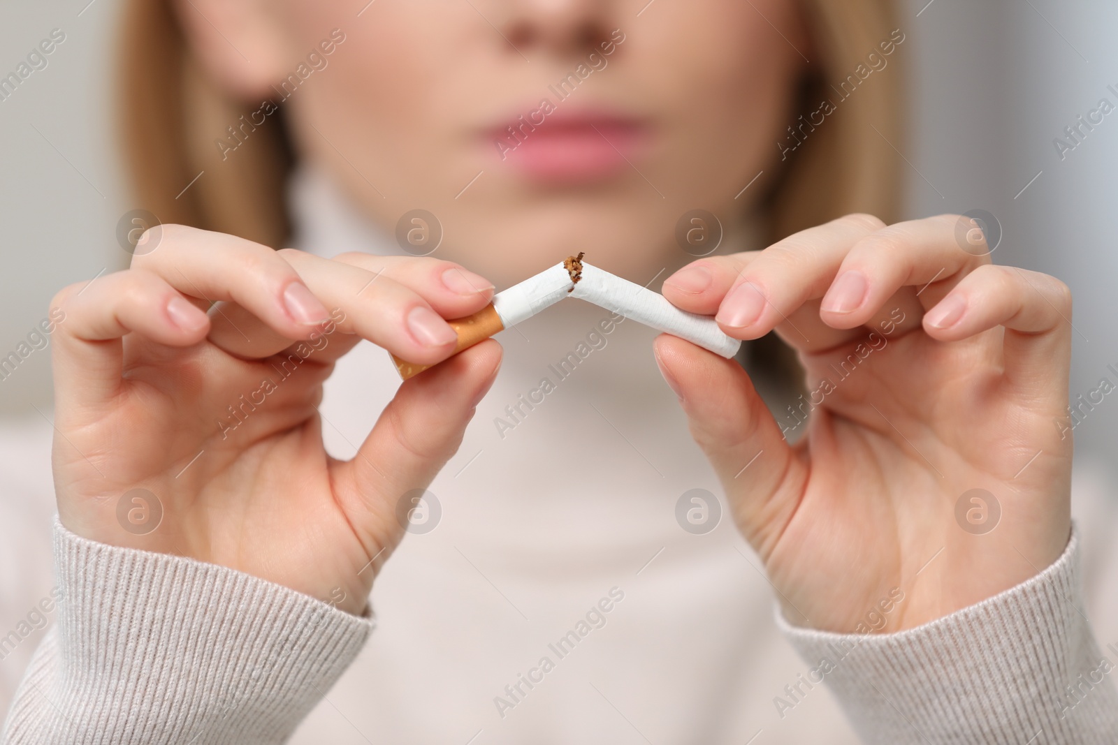 Photo of Stop smoking concept. Woman breaking cigarette, closeup