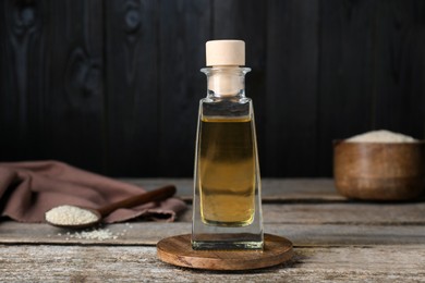 Bottle of organic sesame oil on wooden table