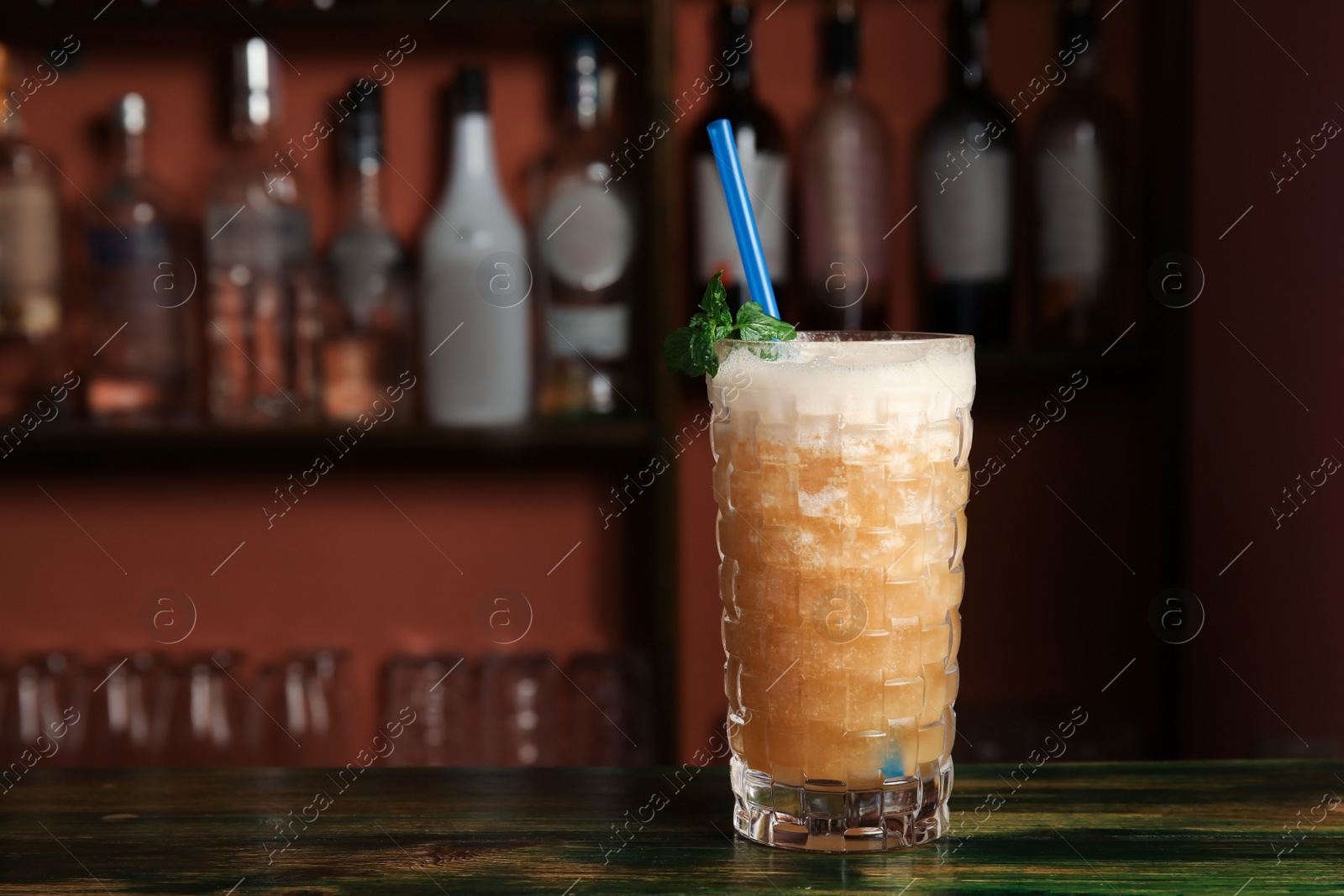 Photo of Glass with delicious cocktail on table in cafe