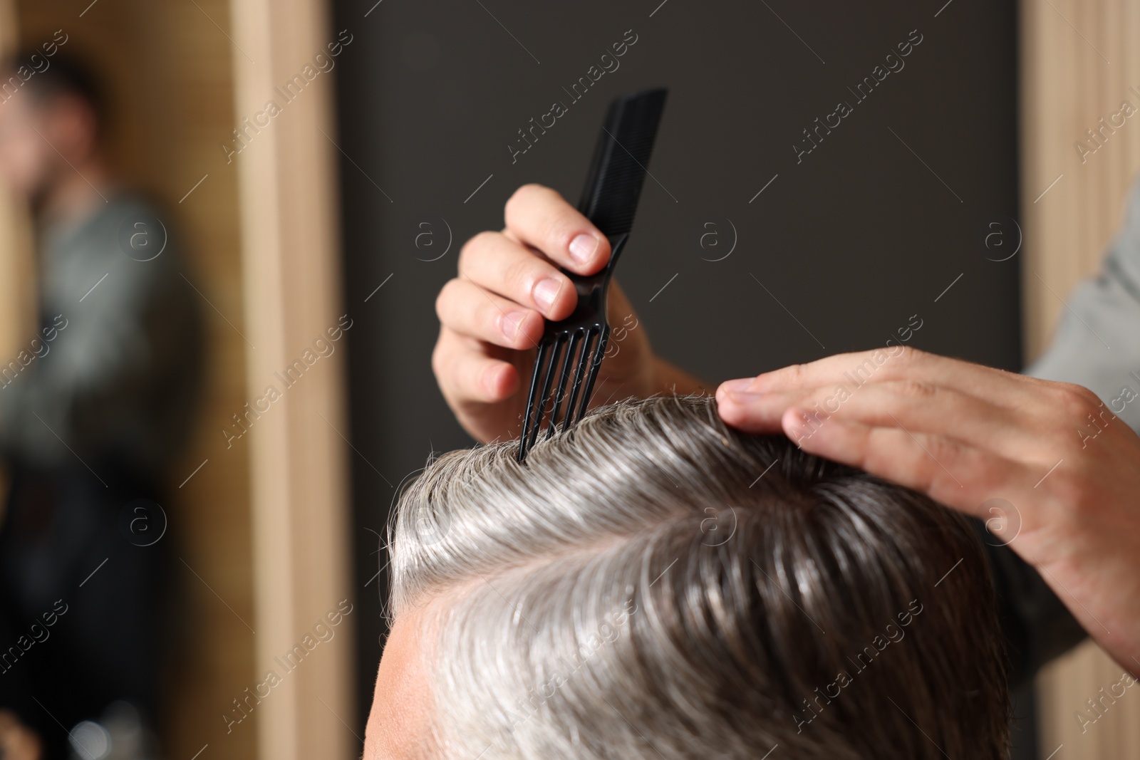 Photo of Hair styling. Professional hairdresser working with client in barbershop, closeup