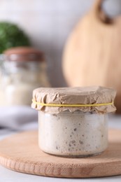 Photo of Sourdough starter in glass jar on table