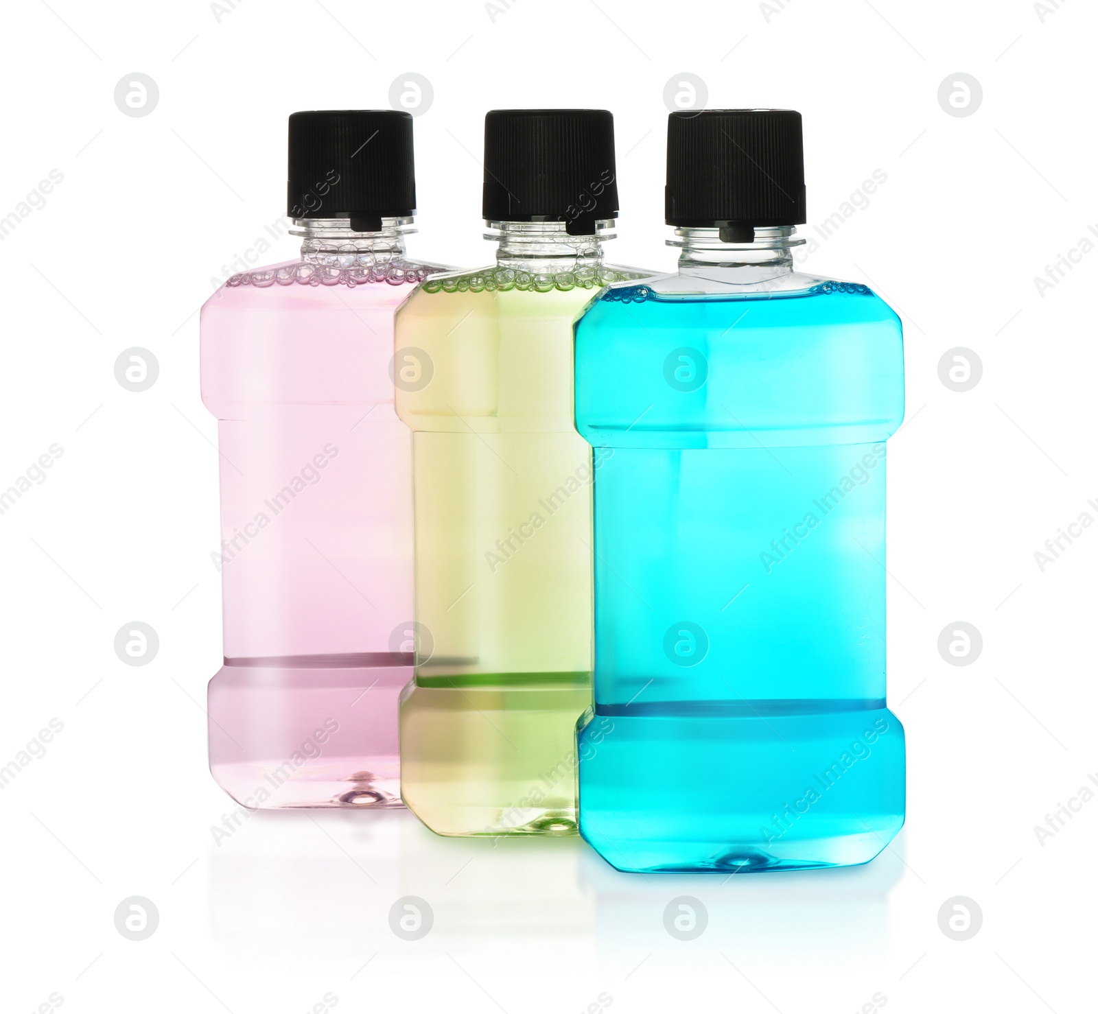 Photo of Bottles with mouthwash for teeth care on white background