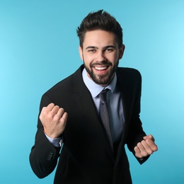 Photo of Portrait of happy young businessman on color background