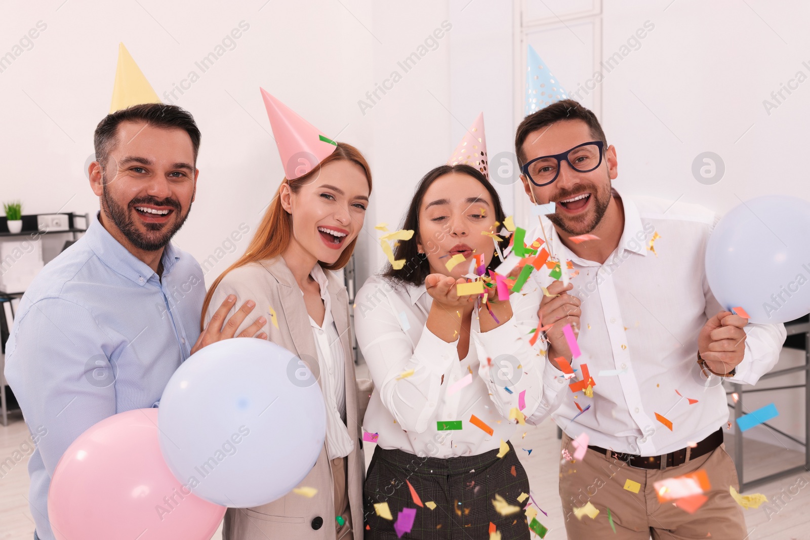 Photo of Coworkers having fun during office party indoors