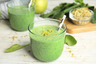 Photo of Green buckwheat smoothie on white wooden table