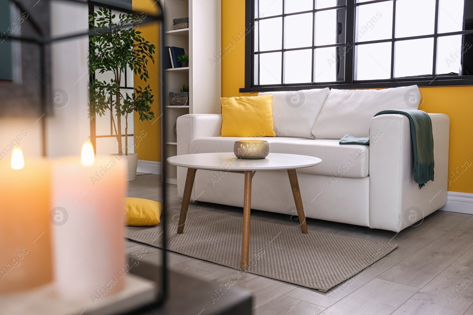 Photo of Elegant living room interior with comfortable sofa and table