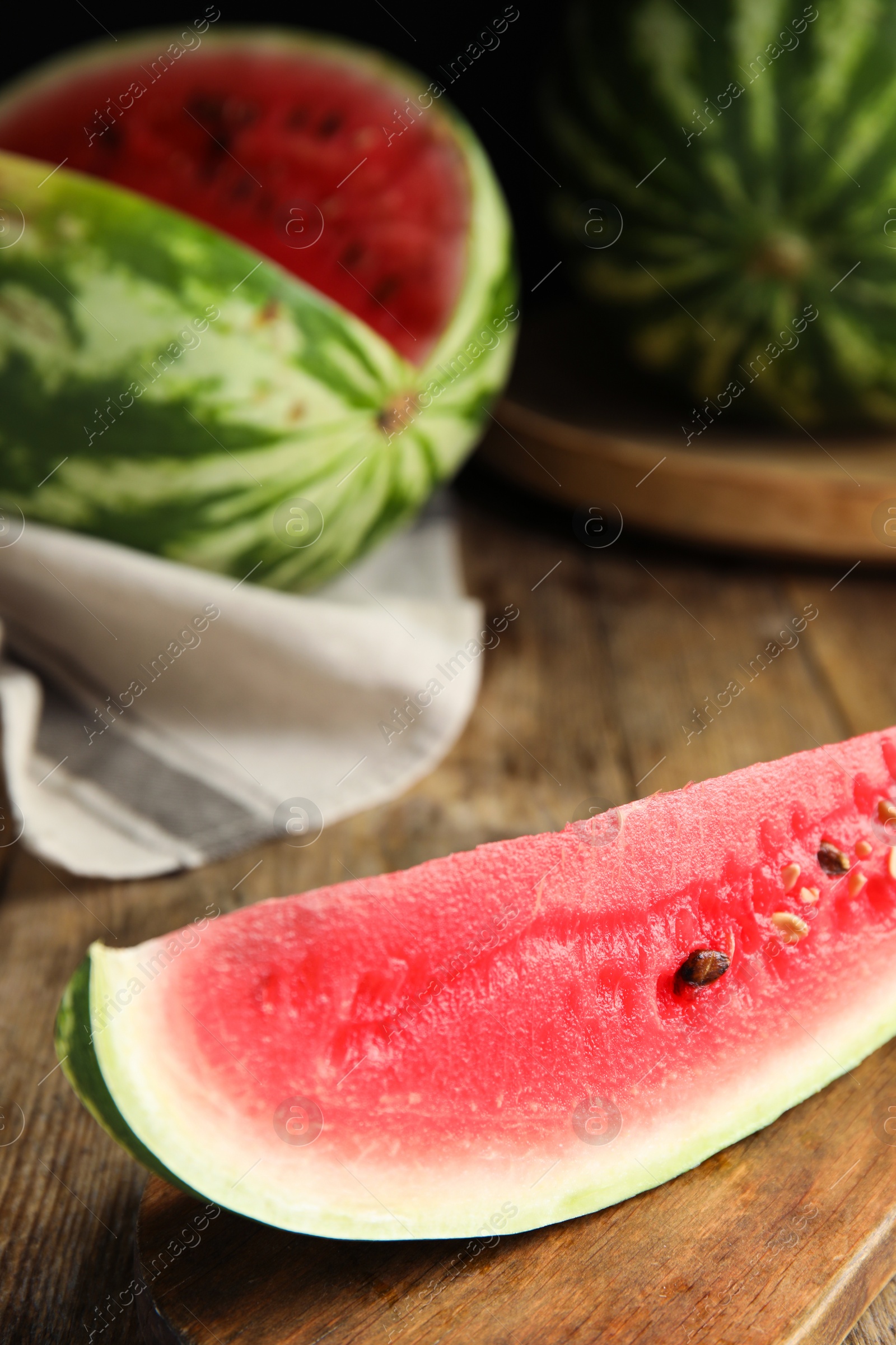 Photo of Yummy watermelon slice on wooden table, closeup