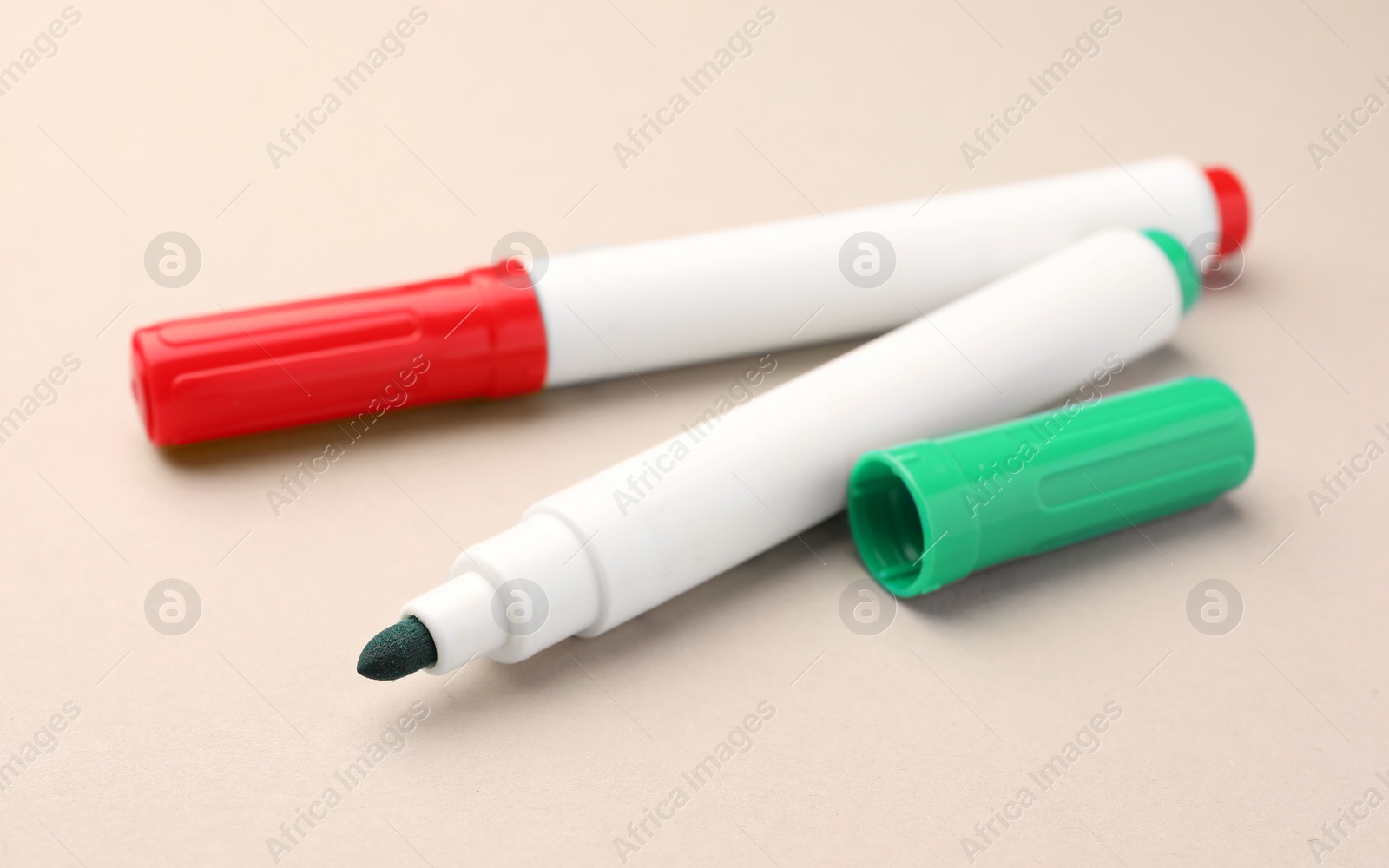 Photo of Bright color markers on beige background. Office stationery