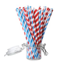 Photo of Striped paper cocktail tubes in jar on white background