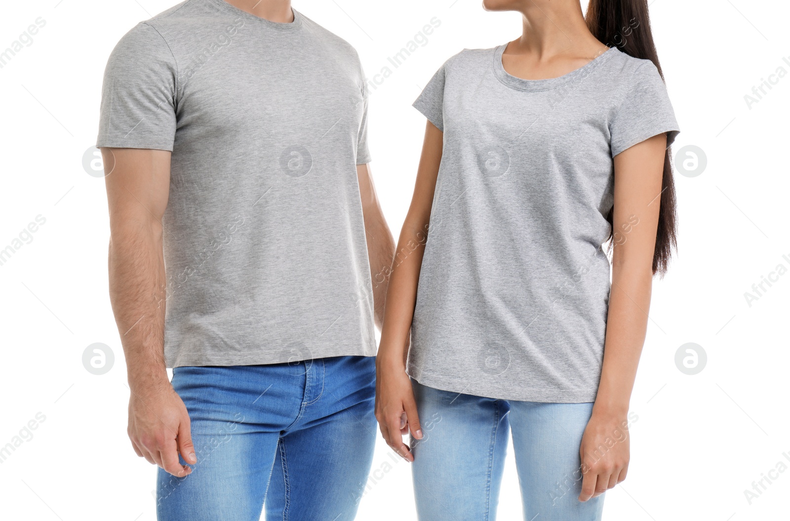 Photo of Young couple in t-shirts on white background. Mockup for design