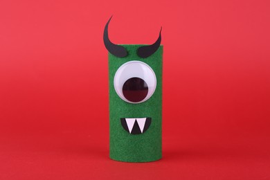 Spooky monster on red background. Handmade Halloween decoration