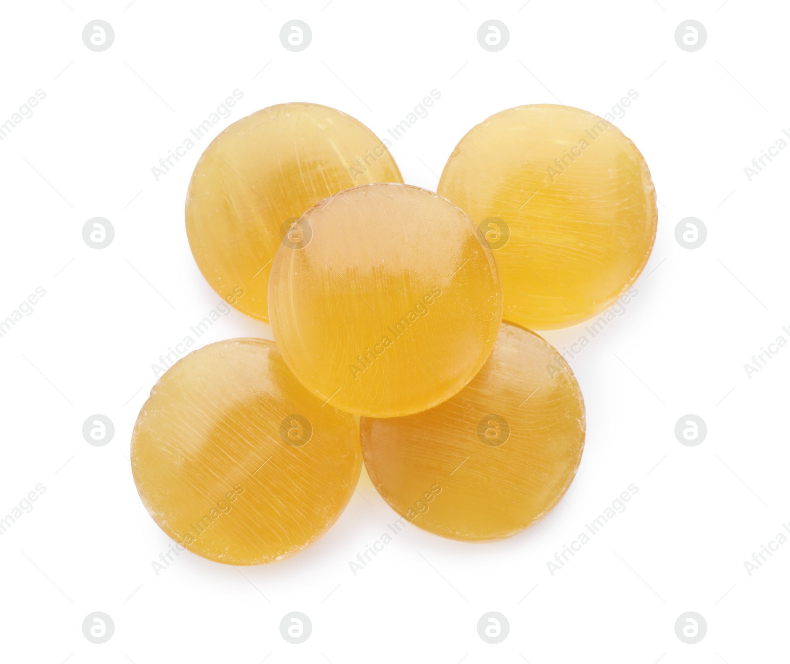Photo of Yellow cough drops on white background, top view