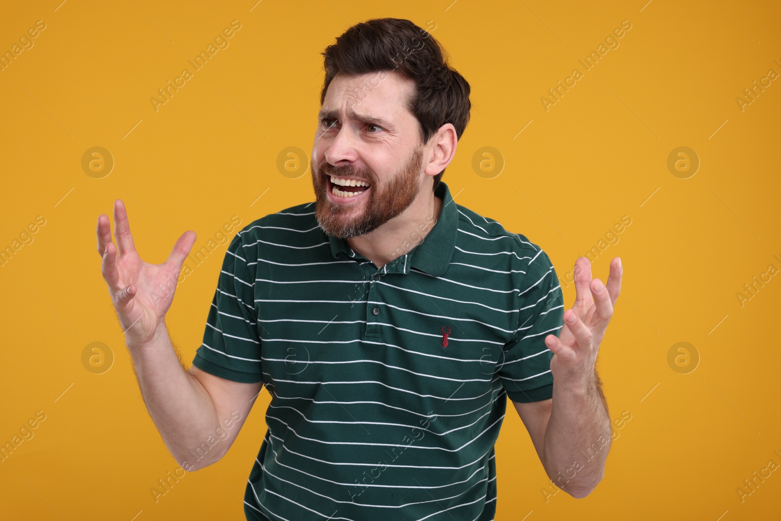 Photo of Portrait of surprised man on yellow background