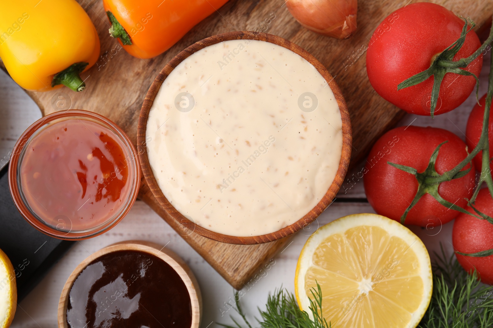 Photo of Different fresh marinades and ingredients on white wooden table, flat lay