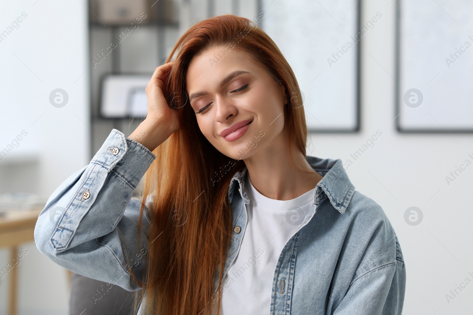 Photo of Portrait of beautiful young woman. Happy lady with red hair at home