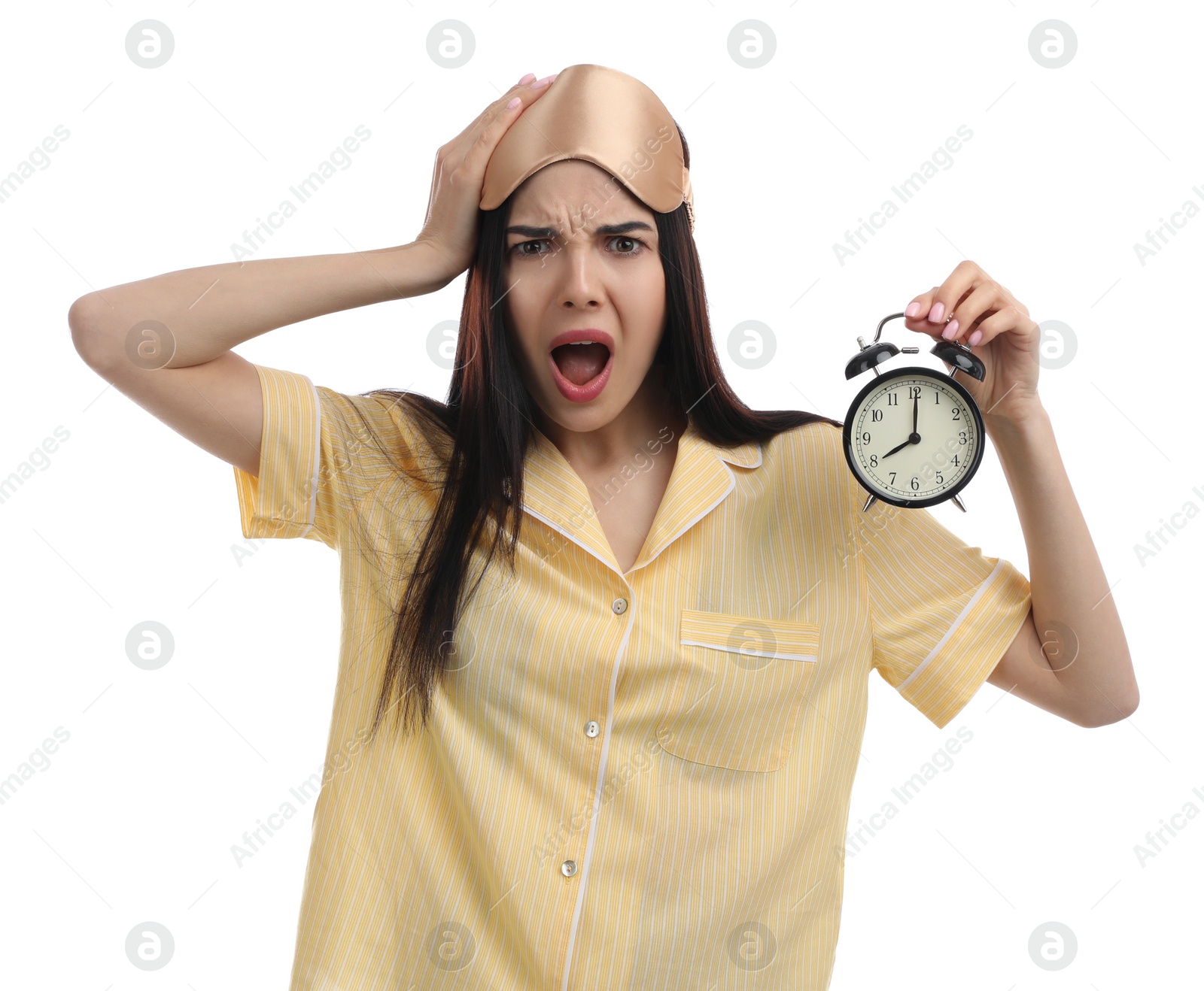 Photo of Emotional overslept woman with alarm clock on white background. Being late concept