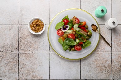 Photo of Delicious salad with vegetables, spinach and olives served on light table, flat lay