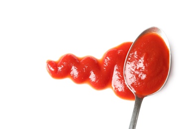 Delicious tomato sauce and spoon on white background, top view