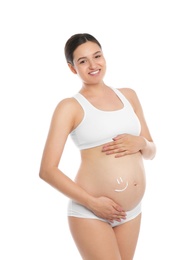 Photo of Pregnant woman with smile painted on her belly against white background. Body cream