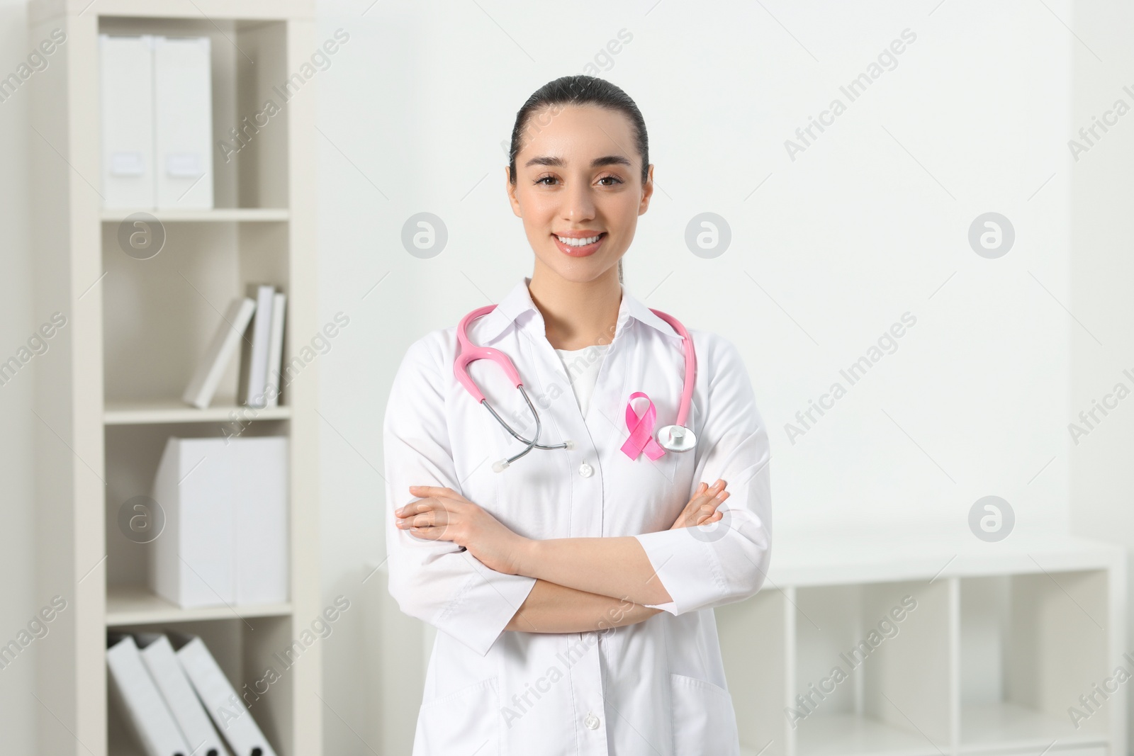 Photo of Mammologist with pink ribbon in hospital. Breast cancer awareness