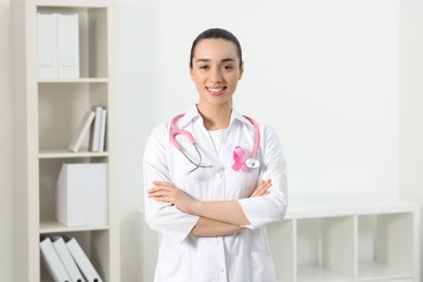 Photo of Mammologist with pink ribbon in hospital. Breast cancer awareness