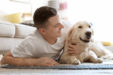 Photo of Portrait of owner with his friendly dog at home