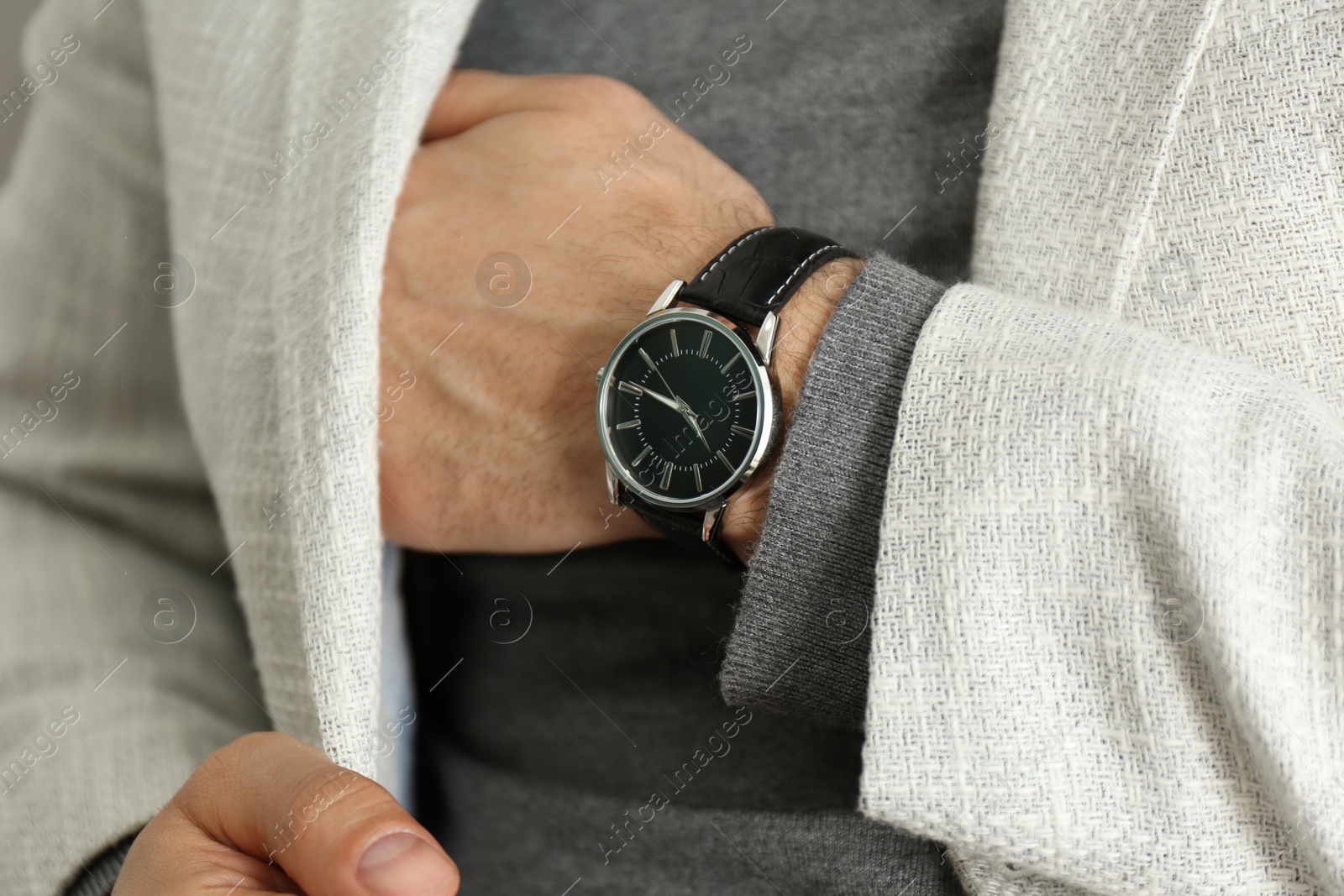 Businessman in jacket with luxury wrist watch, closeup Photo of Businessman in jacket with luxury wrist watch, closeup