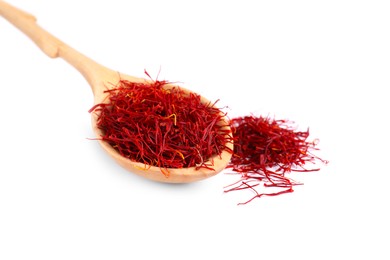 Photo of Dried saffron and wooden spoon on white background