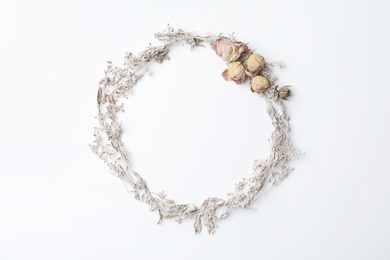 Photo of Dried flowers arranged in shape of wreath on white background, flat lay with space for text. Autumnal aesthetic