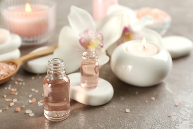 Photo of Beautiful spa composition with essential oil and candles on table