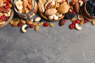 Photo of Composition of different dried fruits and nuts on color background, top view. Space for text
