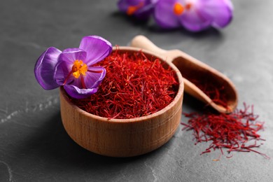 Photo of Dried saffron and crocus flower on grey table