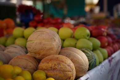 Different fresh ripe fruits on counter at market, closeup