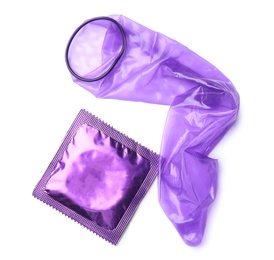 Image of Unrolled violet condom and package on white background, top view. Safe sex