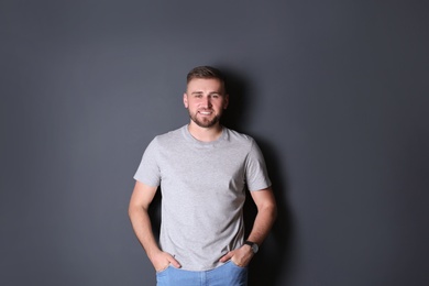 Photo of Portrait of handsome happy man on grey background