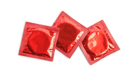 Photo of Condom packages on white background, top view. Safe sex