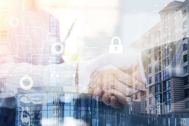 Image of Business people shaking hands and modern buildings, closeup. Double exposure